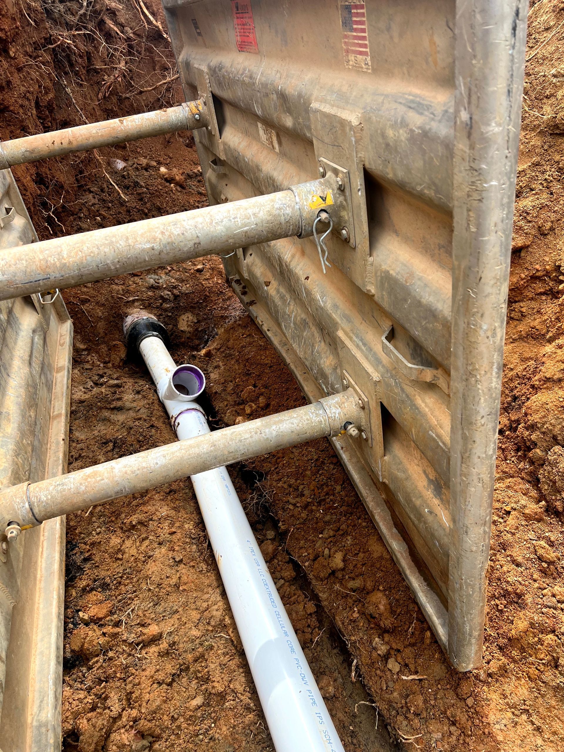 A pipe is being installed in a hole in the ground.