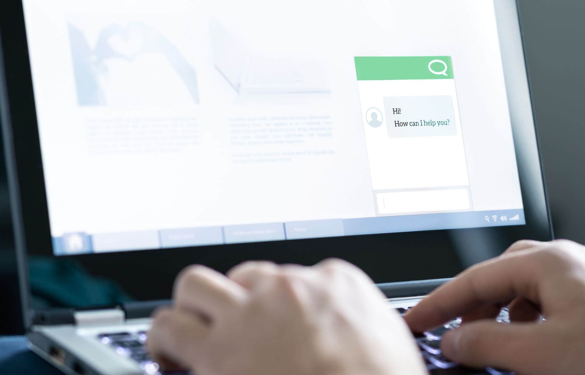 A person is typing on a laptop computer.