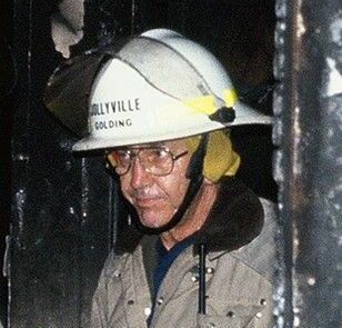 A man wearing a fire helmet with the word Jollyville on it