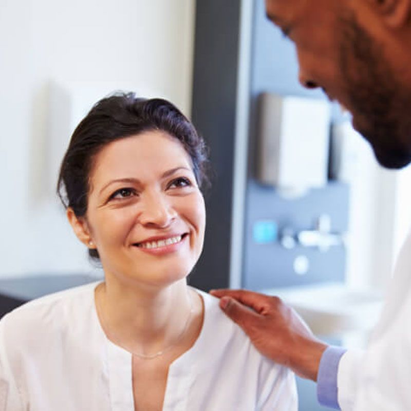 happy women consulting with doctor