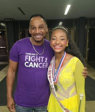 A man is wearing a purple shirt that says fight cancer