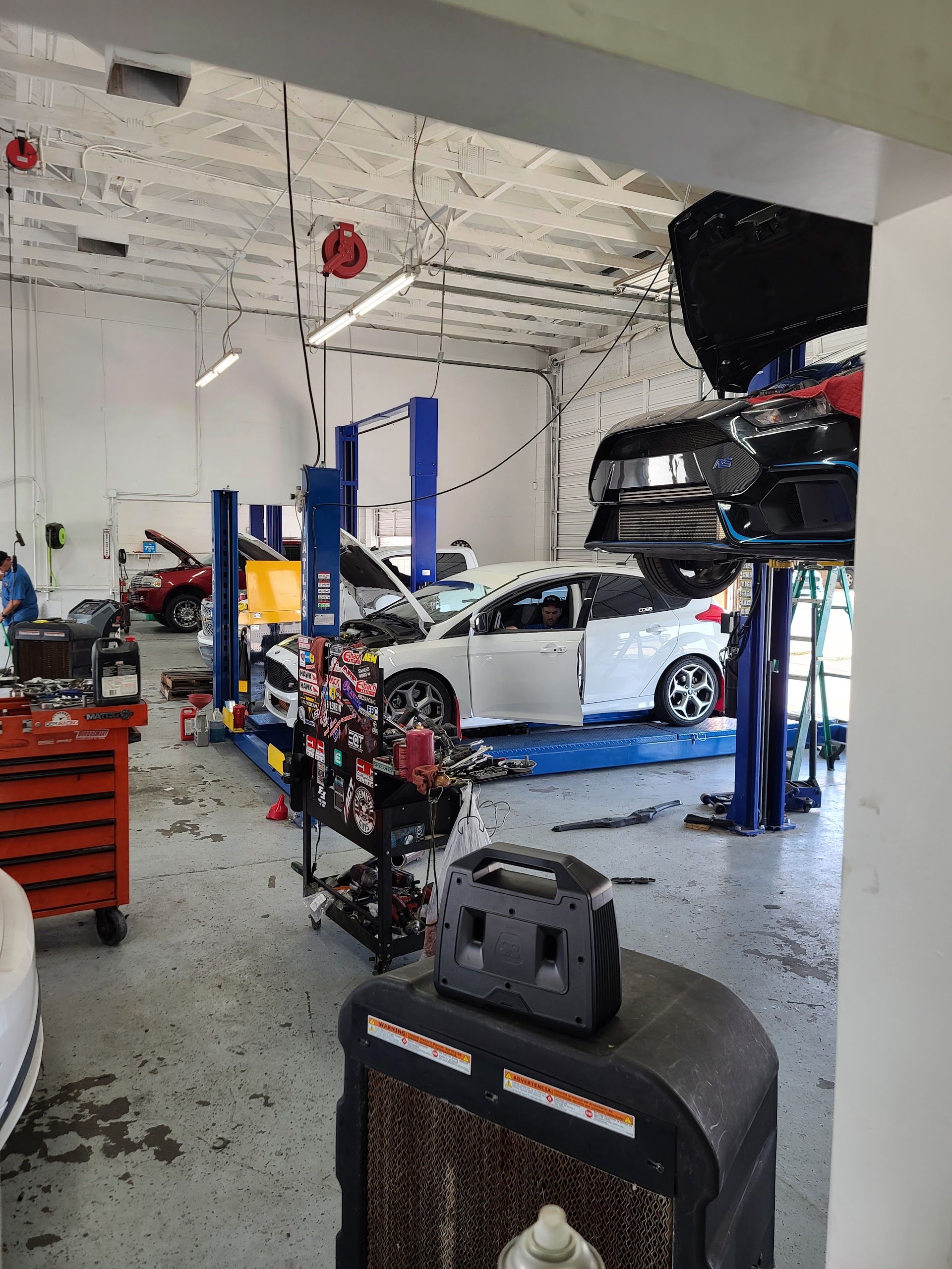 Auto Technicians Performing Vehicle Repairs Inside The Shop | Elston Auto Care