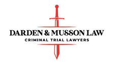 Logo: Red sword through "Darden & Musson Law, Criminal Trial Lawyers."