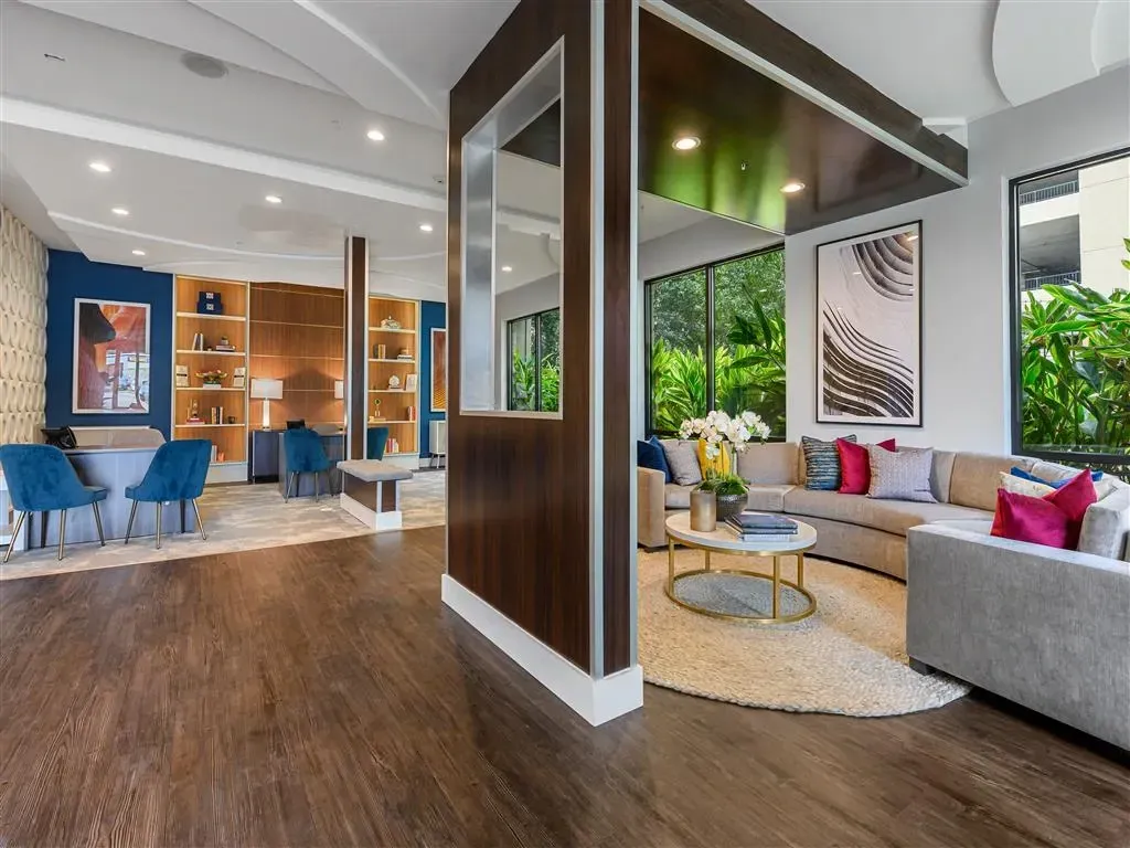 Stylish lobby with comfortable seating areas and lush greenery views.