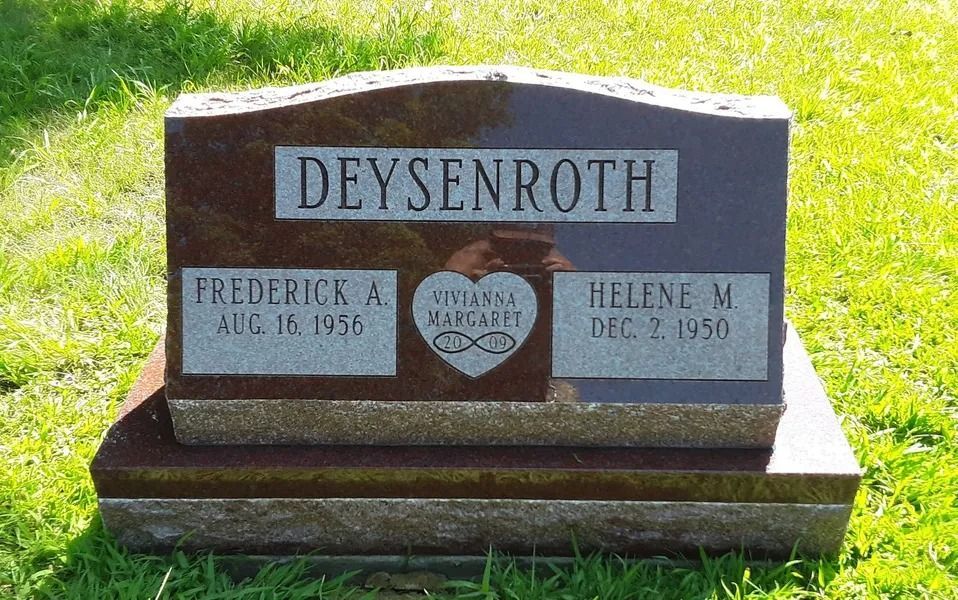 Headstone for the Deysenroth family, with names and dates, set in grass.