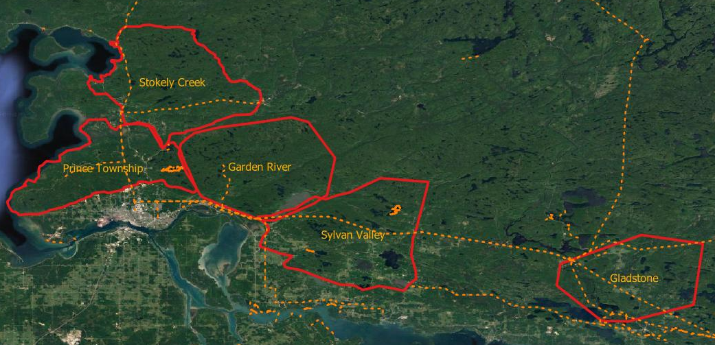 Aerial map with five red-outlined zones labeled across a green forested landscape.
