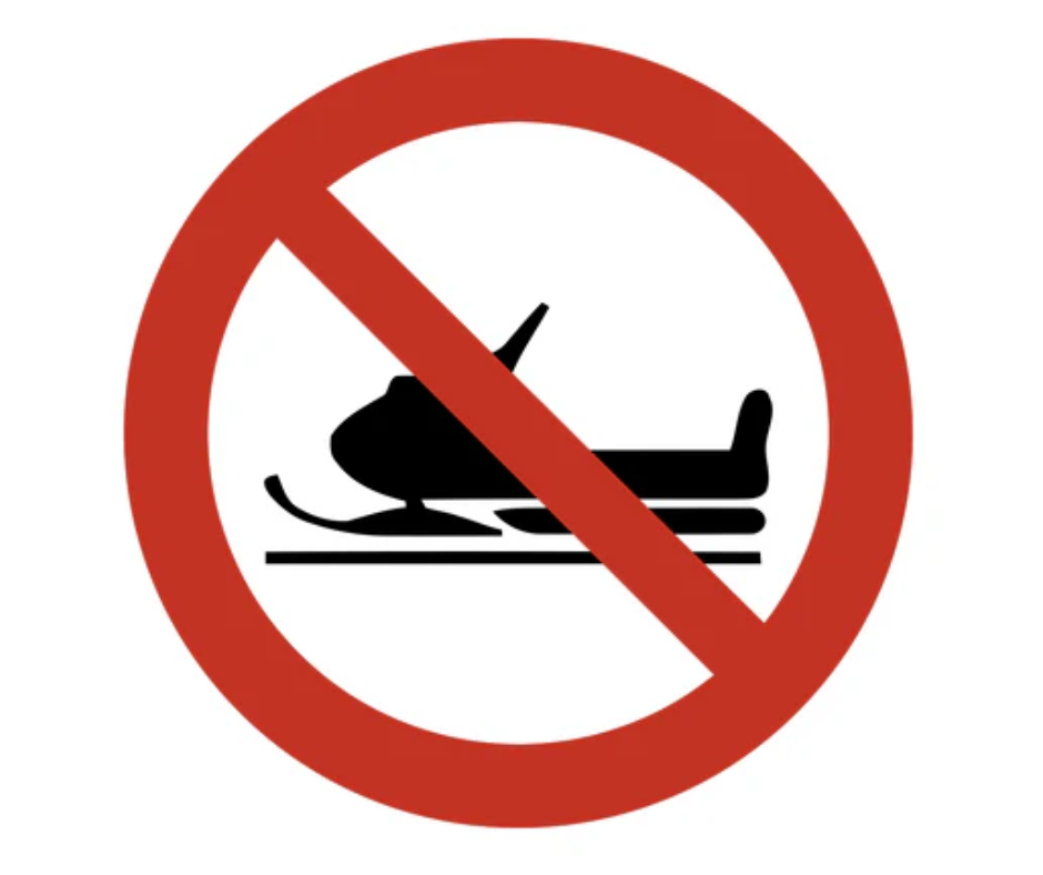 No snowmobiles sign: Red circle with a red diagonal slash over a black snowmobile.