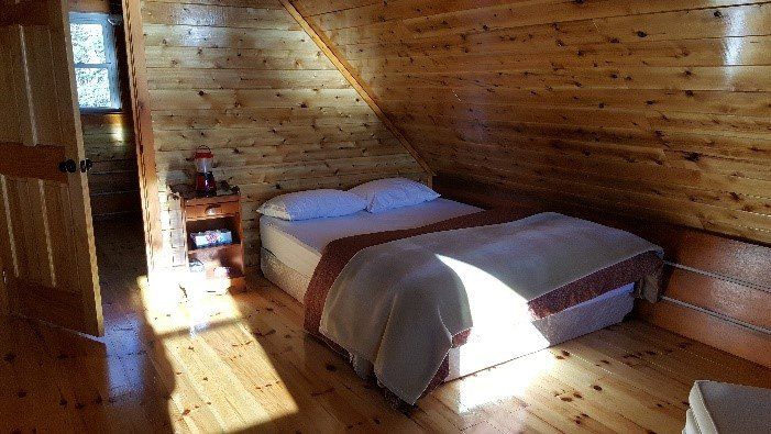 queen bed Norm's Cabin