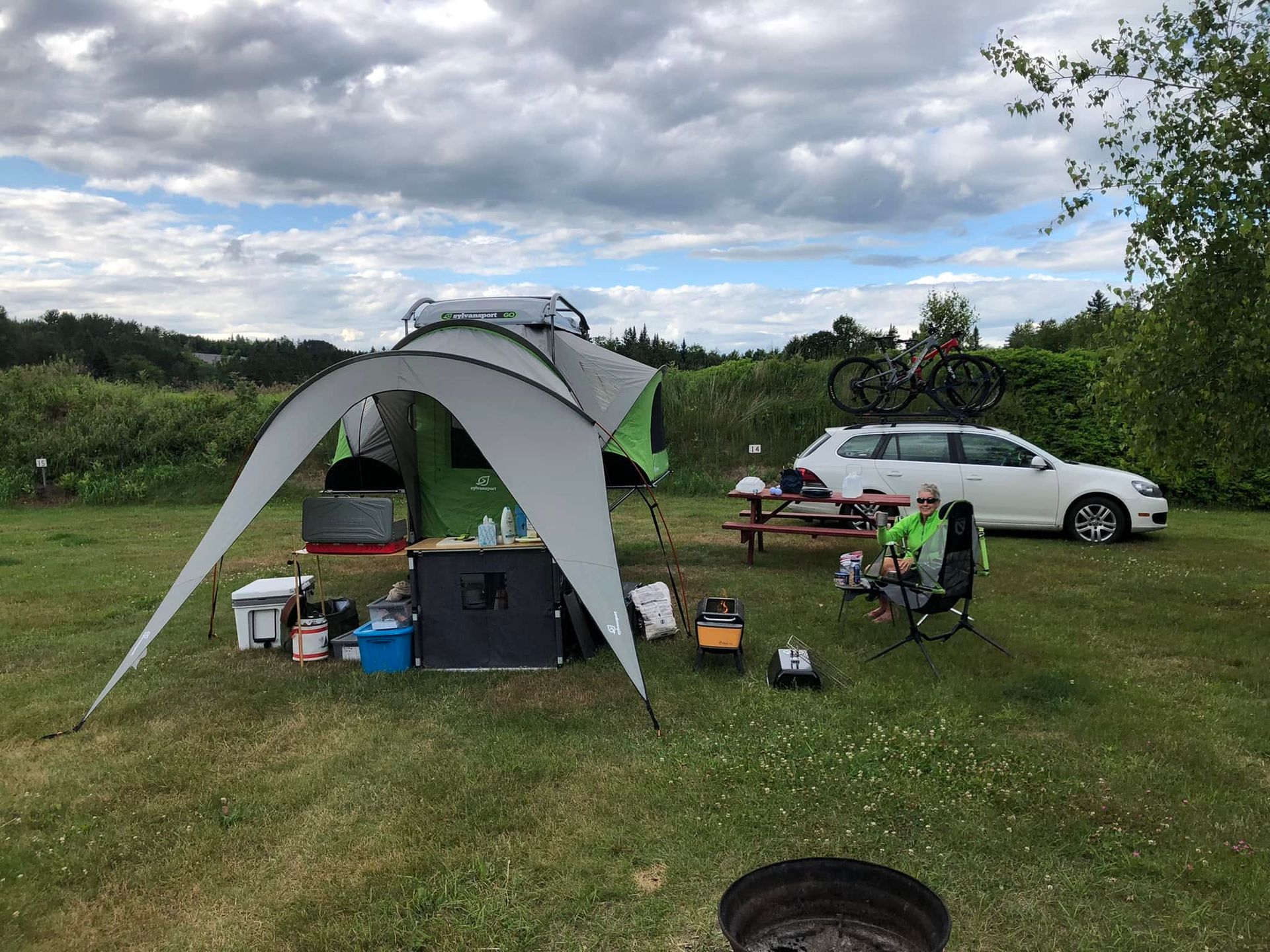 Vermont campsite with picnic table and stone fire pit in morning light