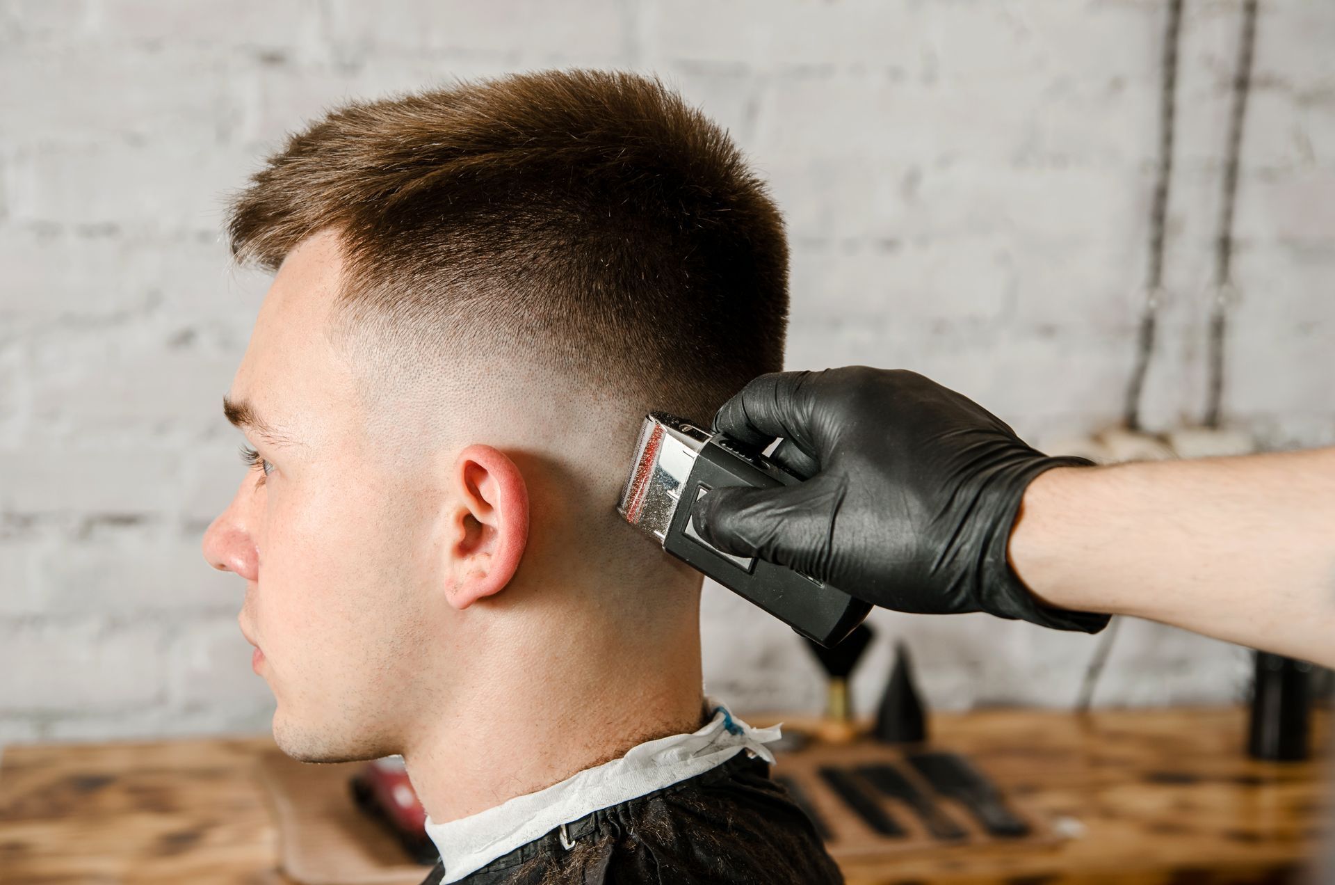 A young man getting his hair cut before school starts.