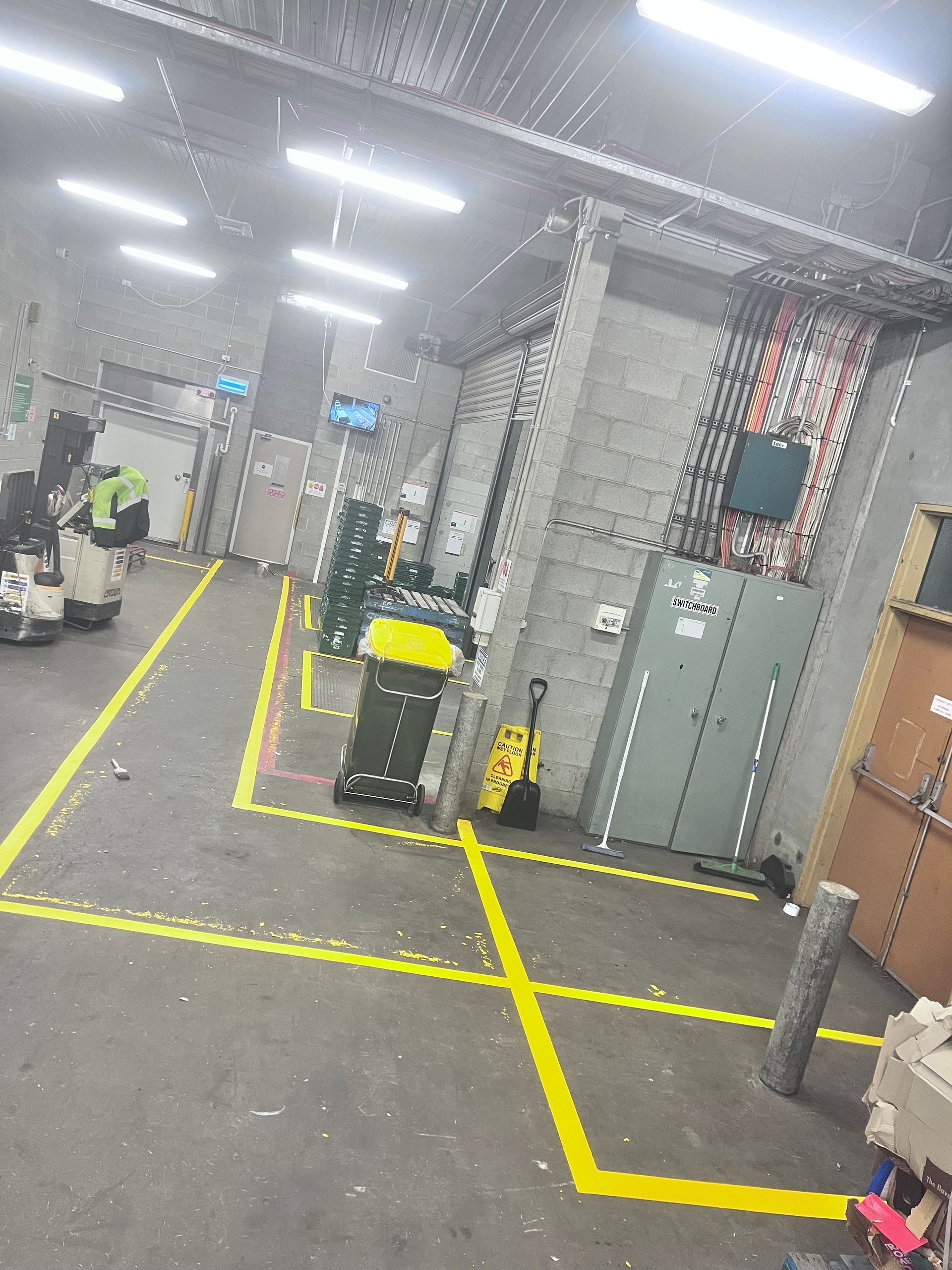 A warehouse with a lot of yellow lines on the floor — Hobart, TAS — Campbell Painters Pty Ltd
