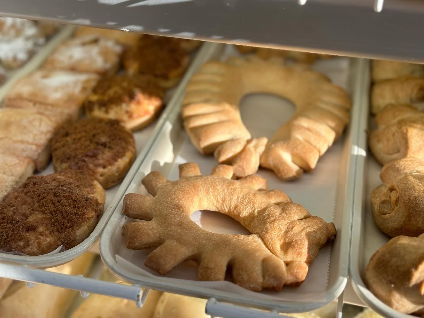 A variety of pastries are on display in a bakery