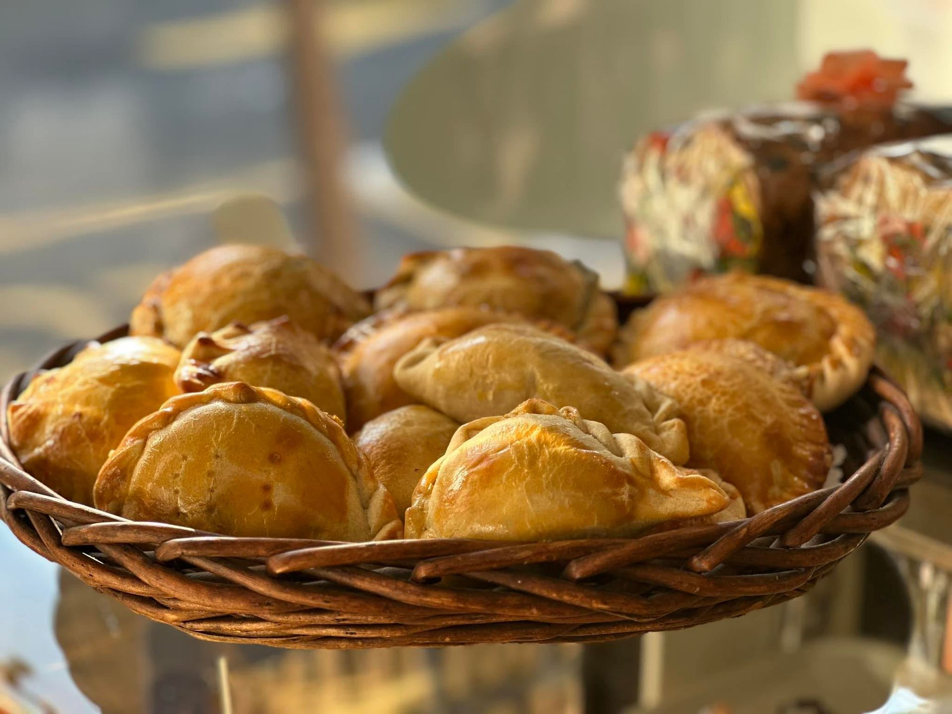 A basket of pastries is sitting on a table.