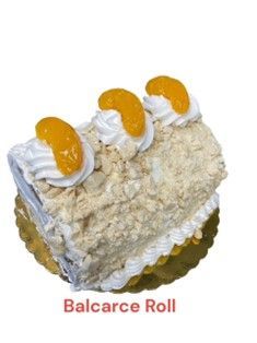 A balcarce roll cake with whipped cream and oranges on top