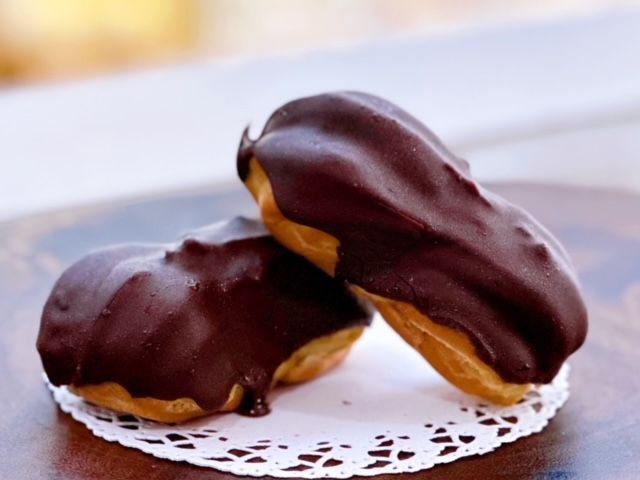 Two chocolate covered pastries on a white napkin