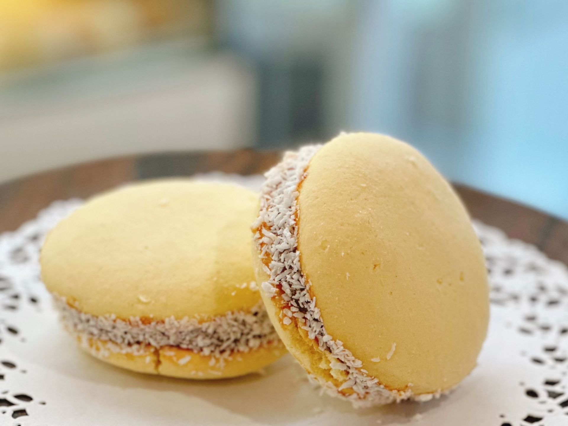 A close up of two cookies on a plate on a table.