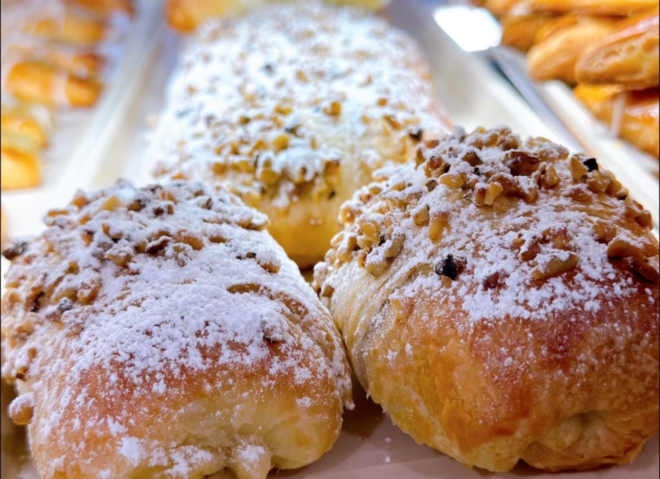 A bunch of pastries with powdered sugar on them