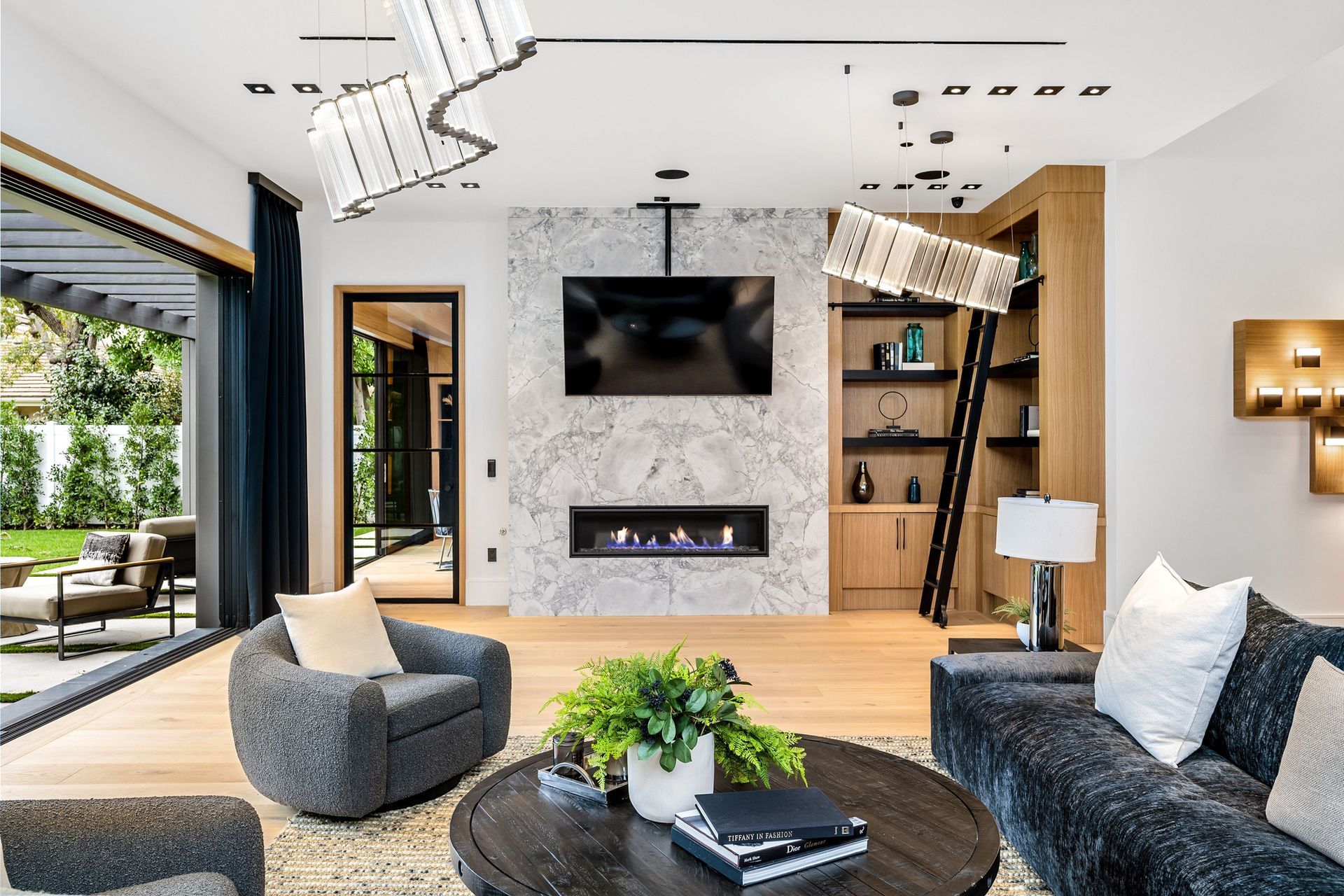 A living room with a fireplace and a tv above it.