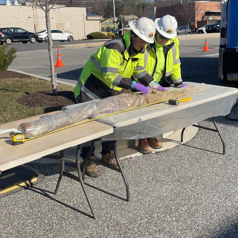Two ARM Group field technicians examining soil cores on-site during petroleum vapor intrusion investigation.