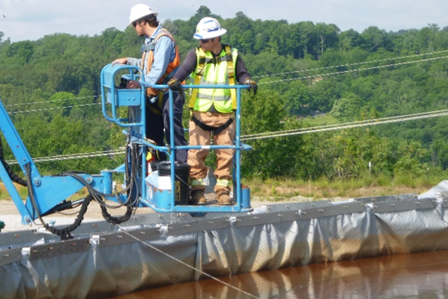 two people inspecting an aboveground storage tank on site | ARM Group Natural Gas Services