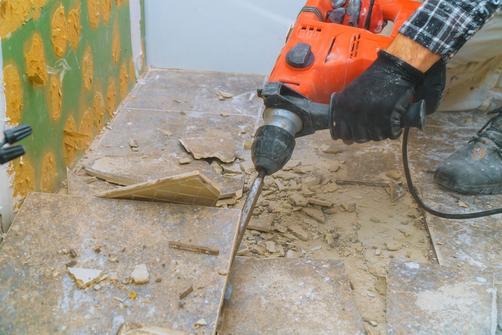 Hammer and pry bar on a worn wooden floor under construction