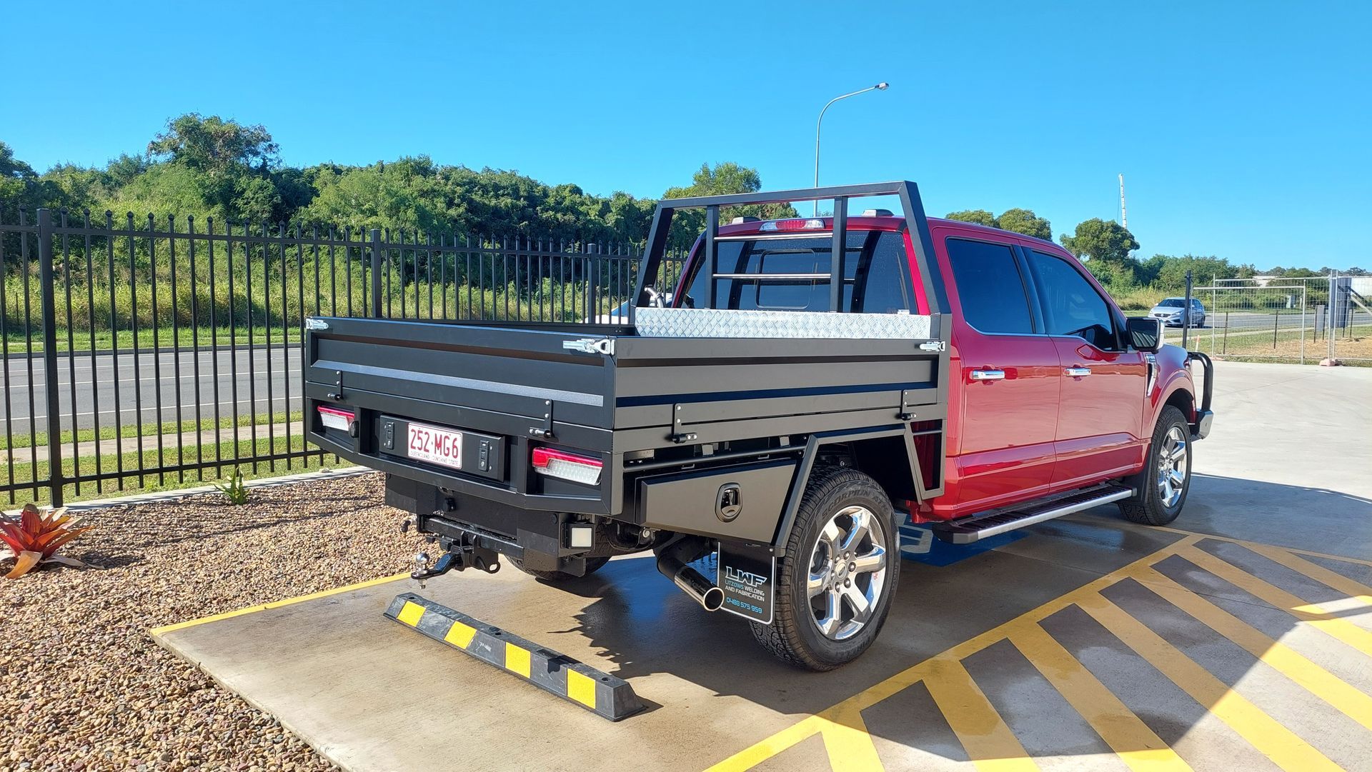 Red Pickup Truck With a Black Tray Bed Parked — Litzow’s Welding & Fabrication in Dundowran, QLD