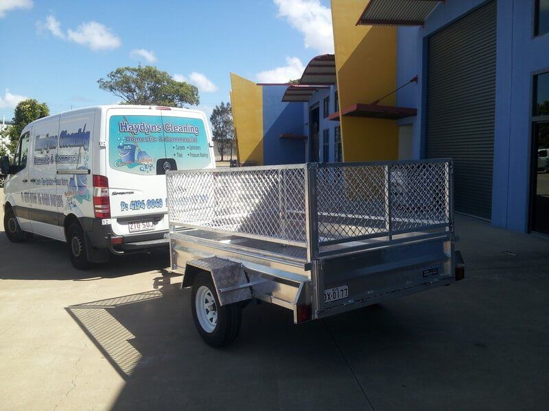 White Van Towing a Silver Utility Trailer — Litzow’s Welding & Fabrication in Dundowran, QLD