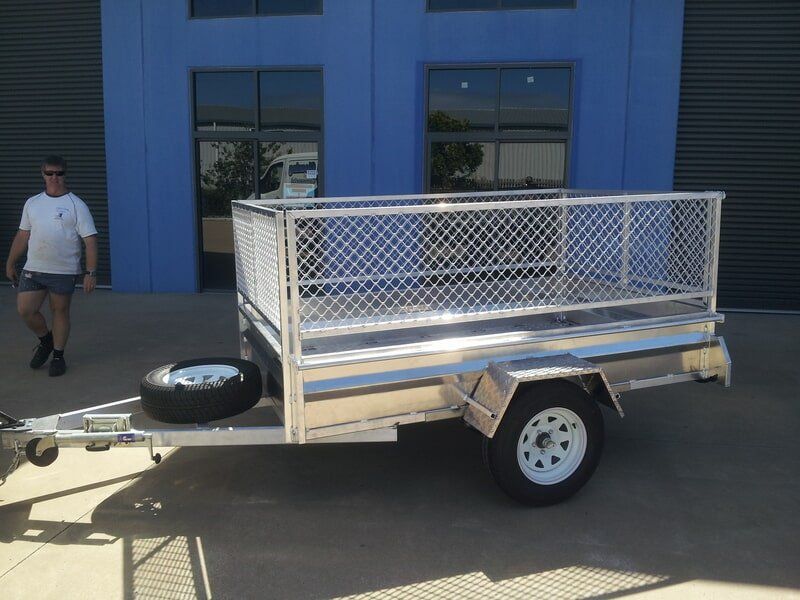 Silver Trailer With Mesh Sides and a Spare Tire — Litzow’s Welding & Fabrication in Dundowran, QLD