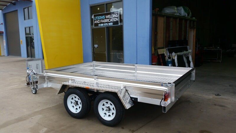 Silver Aluminum Trailer With White Wheels — Litzow’s Welding & Fabrication in Dundowran, QLD