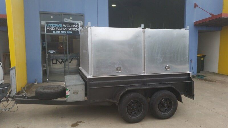 Aluminum Storage Boxes on a Black Trailer Parked — Litzow’s Welding & Fabrication in Dundowran, QLD