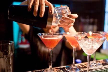 A Bartender Is Pouring A Cocktail Into A Martini Glass — Sports Bar in Port Macquarie, NSW