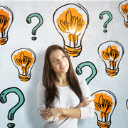 Woman smiling with arms crossed, surrounded by lightbulbs and question marks on a white background