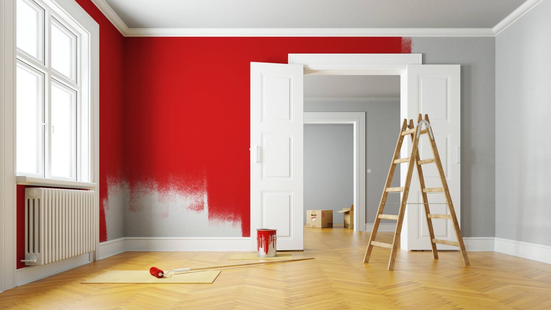 Room with red painted wall, white trim, ladder, and paint supplies on wooden floor.
