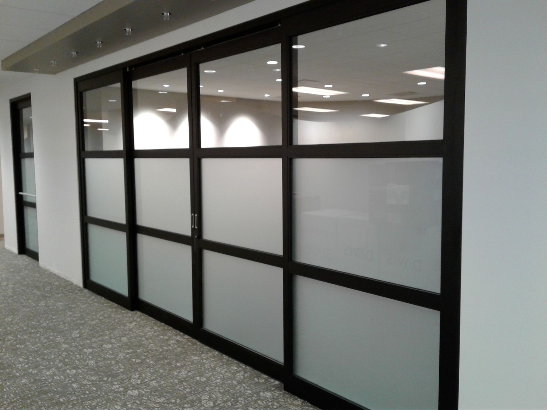 A hallway with a row of sliding glass doors