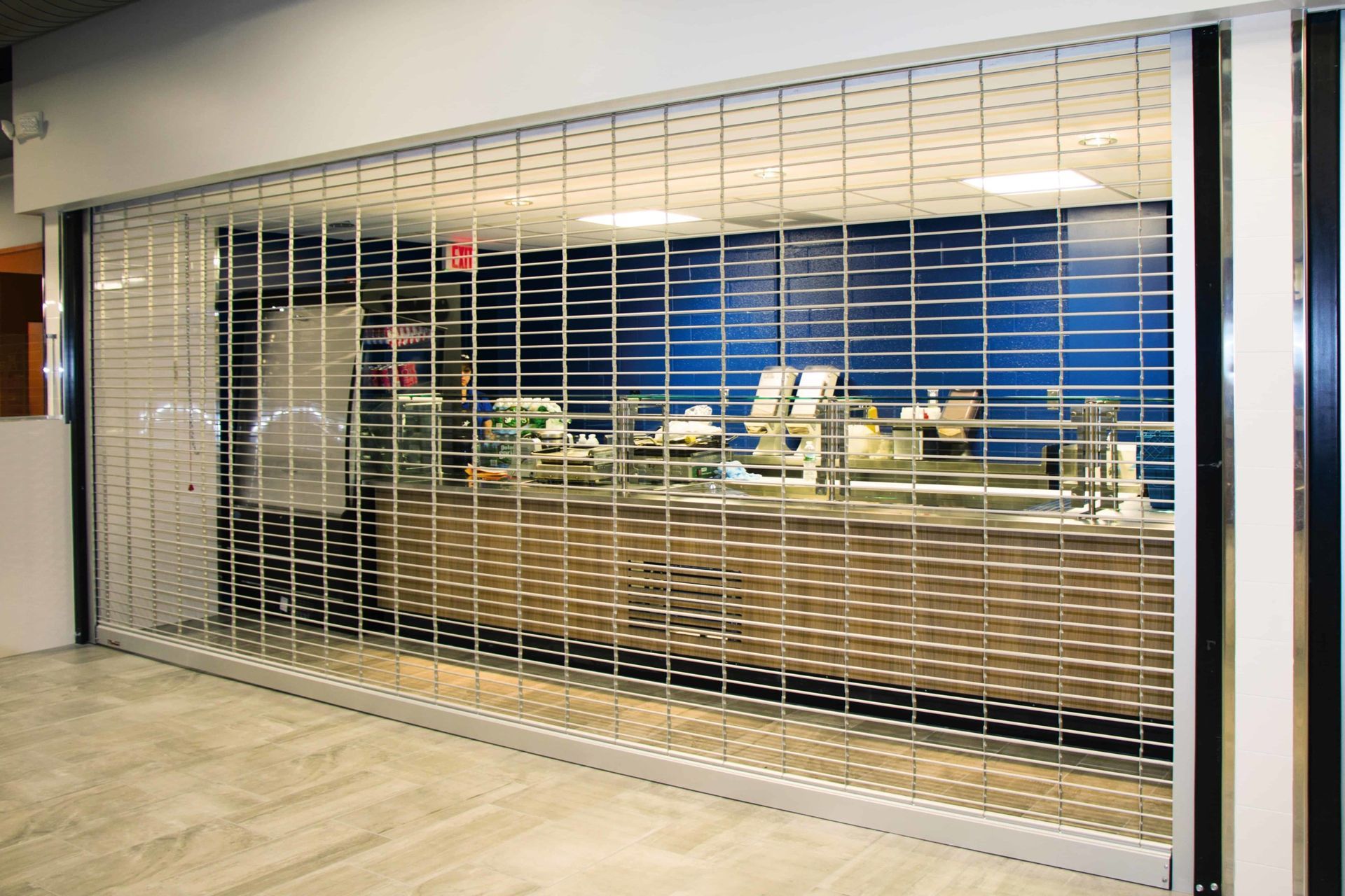 A restaurant with a sliding glass door and a counter behind it.
