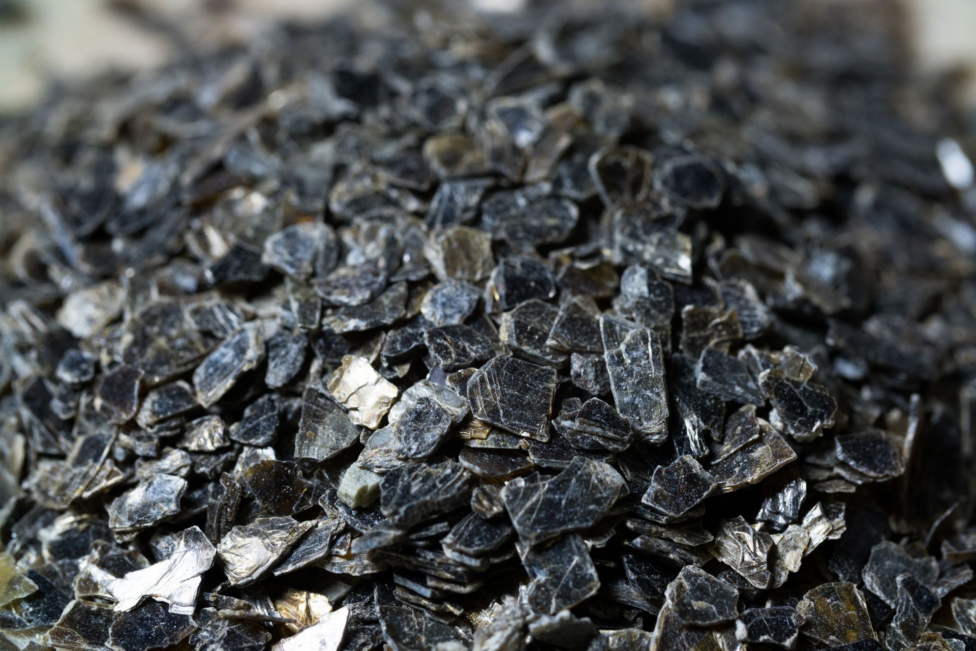 A pile of black rocks is sitting on a table.