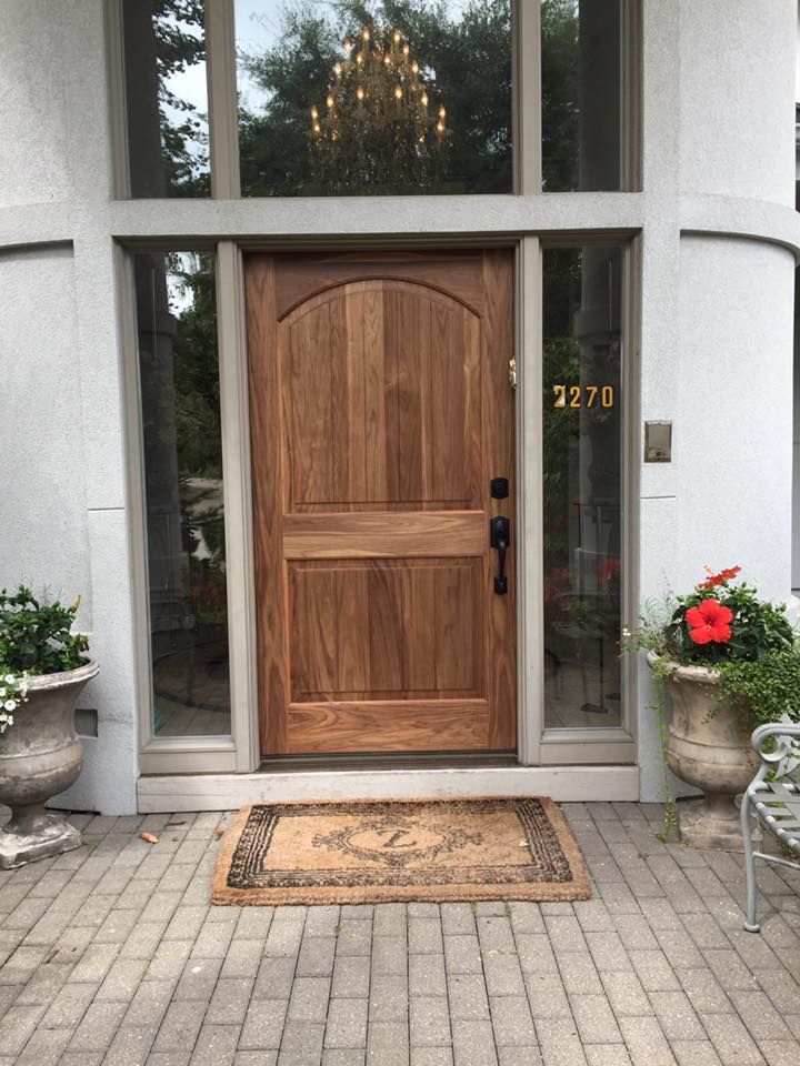 Wooden front door with sidelights, address 