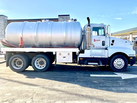 A large tanker truck is parked in a parking lot.