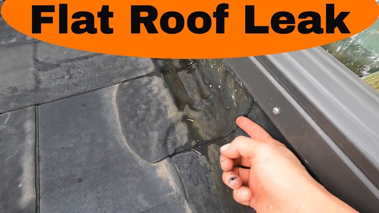 A hand points to a leak near the flashing of a dark-tiled roof, beneath an orange banner reading