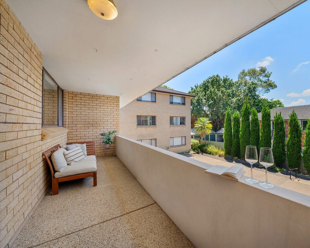 A balcony with a wooden bench, a stone floor — Brightside Buyers Agency in Dundas, NSW