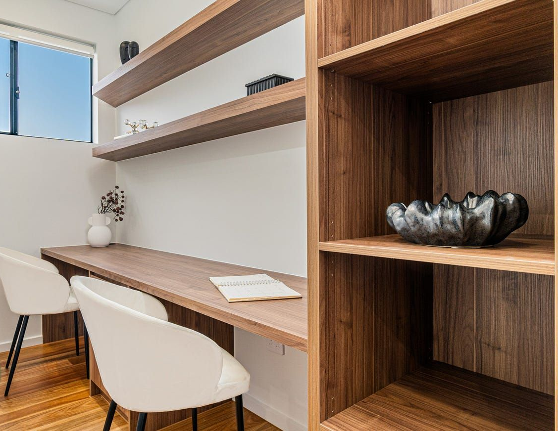 A Home Office With a Long Wood Desk, Two White Chairs — Brightside Buyers Agency in Dundas, NSW