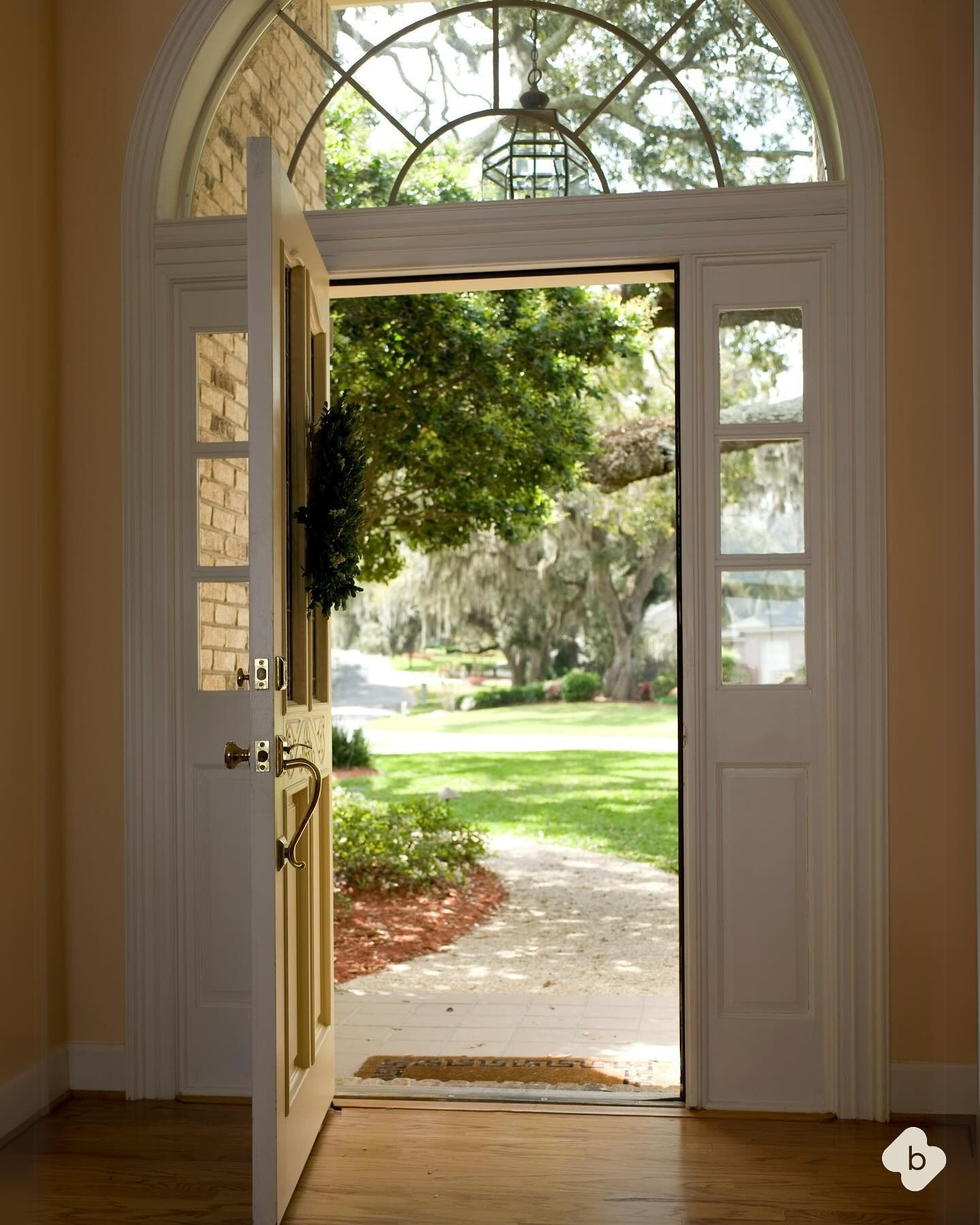 Open Front Door With Arched Window, Looking Out Onto a Sunny Green Lawn — Brightside Buyers Agency in Dundas, NSW