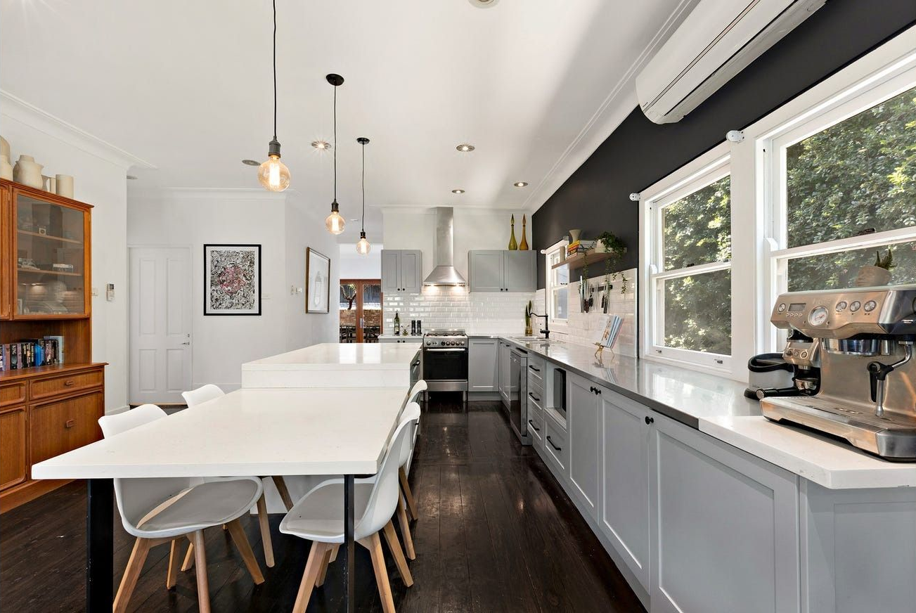 A Bright, Modern Kitchen Features Light Grey Cabinets — Brightside Buyers Agency in Dundas, NSW
