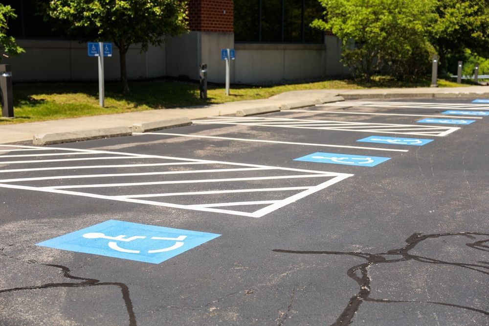 A row of handicapped parking spaces in a parking lot