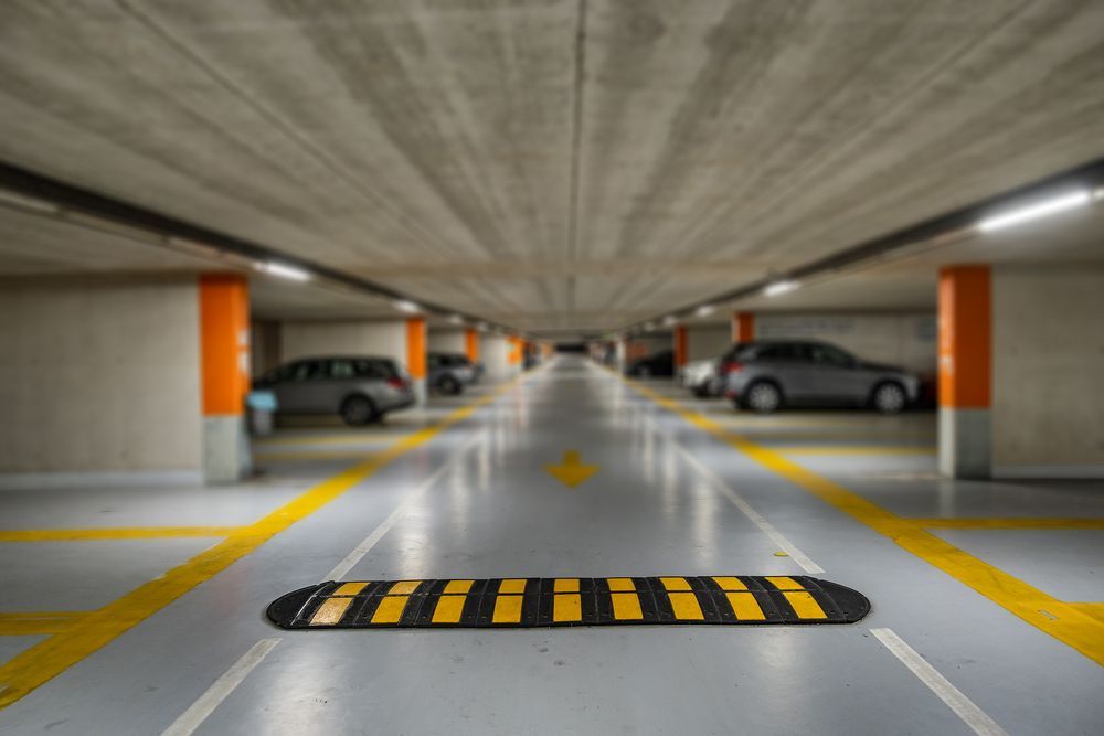 There is a speed bump in the middle of the parking garage.
