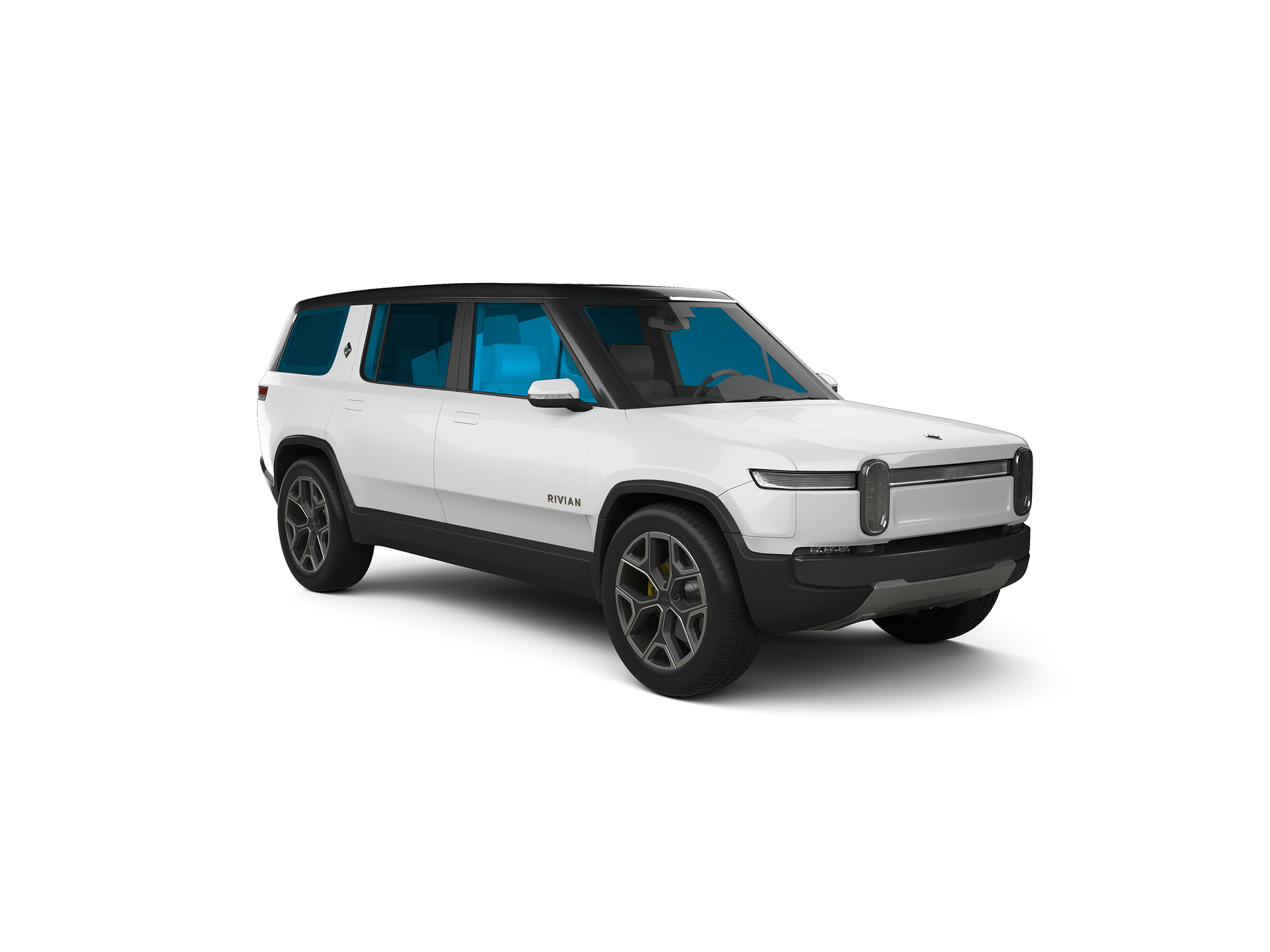 White Rivian SUV with a black roof and tinted windows.