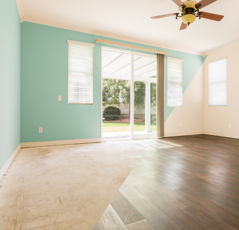 A living room with blue walls and a ceiling fan