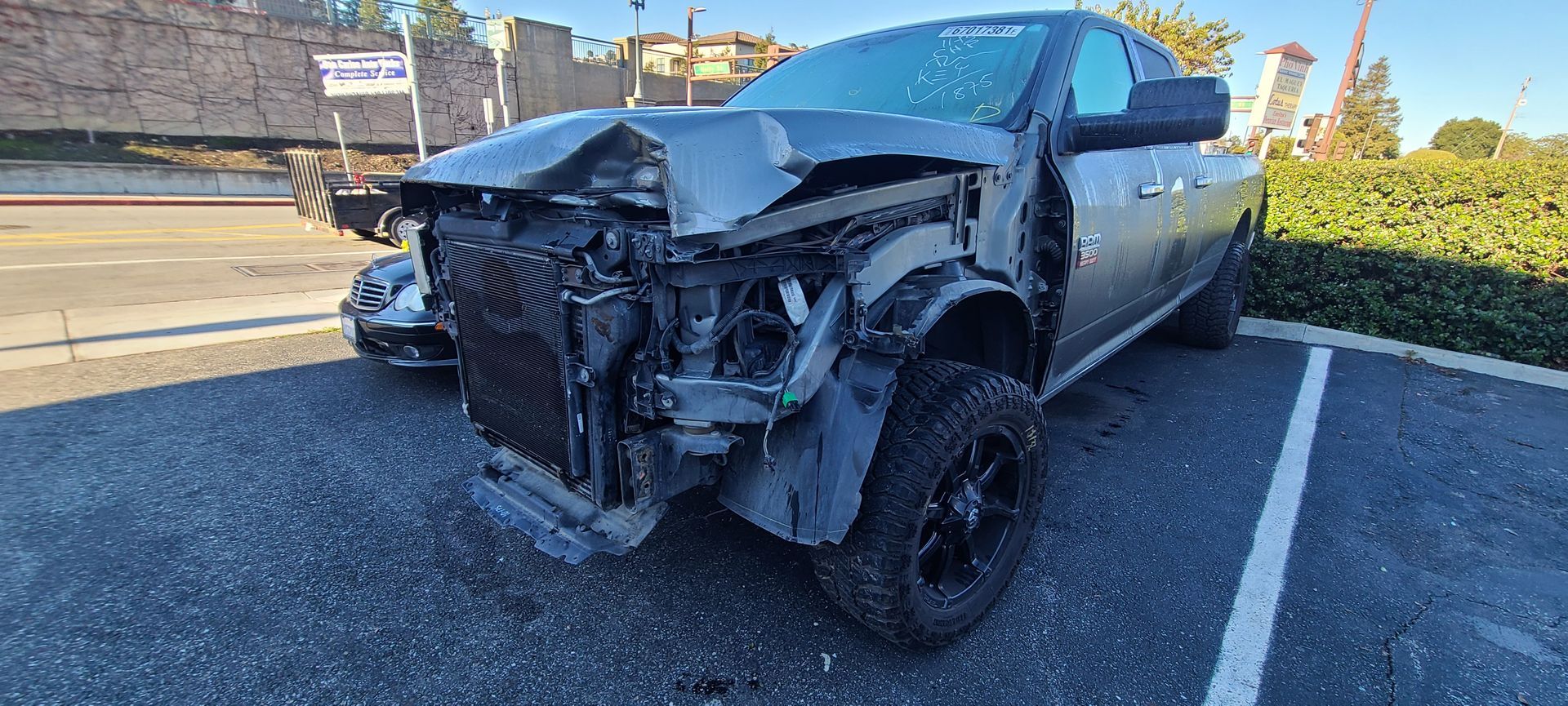 A damaged truck is parked in a parking lot.