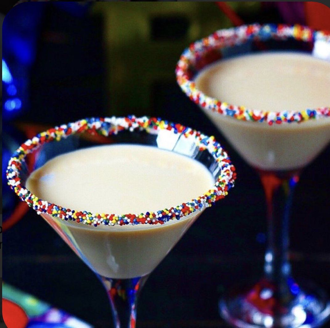 Two martini glasses with sprinkles on the rims