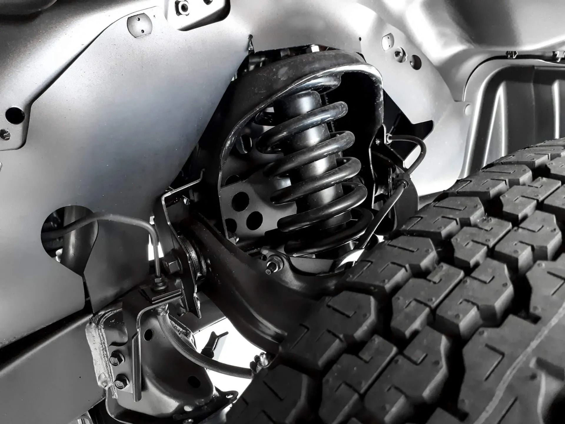 Suspension System With a Coil Spring and Tire — P.K. Head Servicing & Reconditioning in Shellharbour, NSW